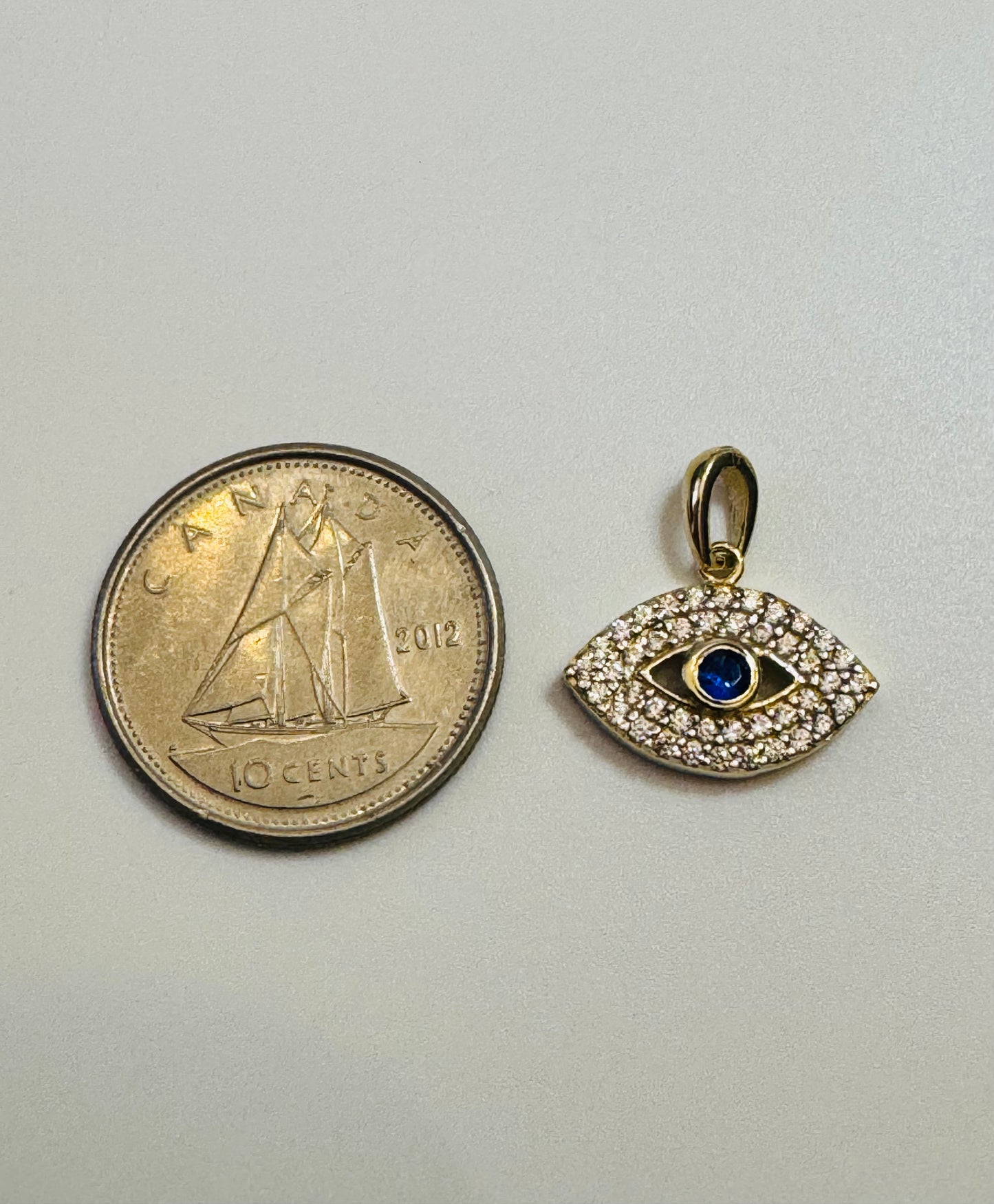 #444 Small 3rd eye pendant with white and blue zircon in 10 carat gold