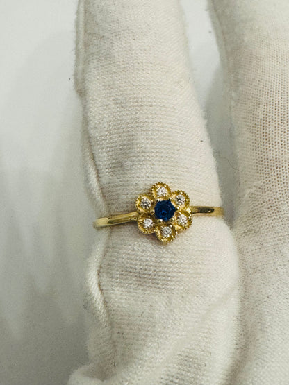 #214 bague en forme de fleurs en zircon centre bleu en or 10k