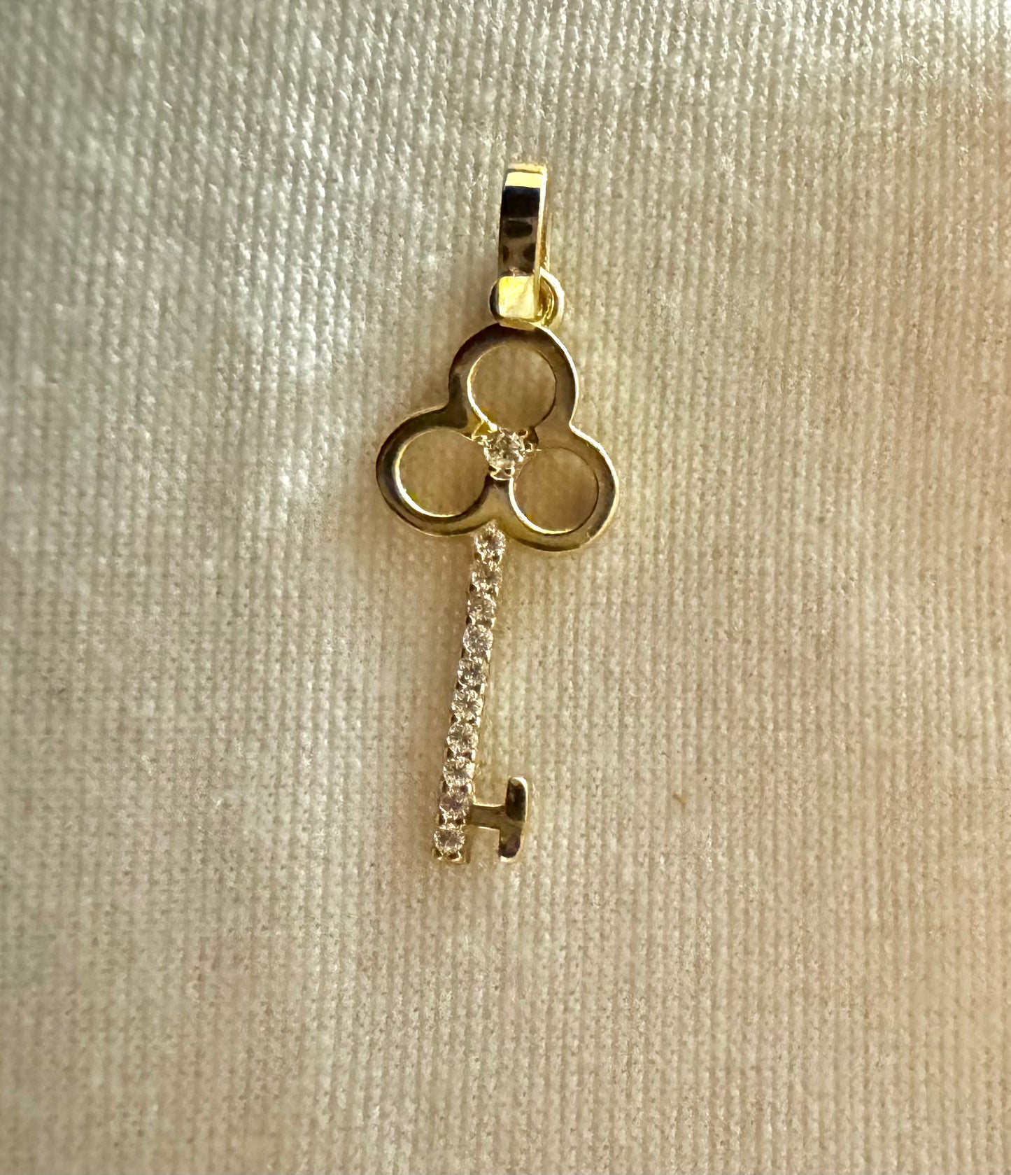 Gold key pendant with zircon