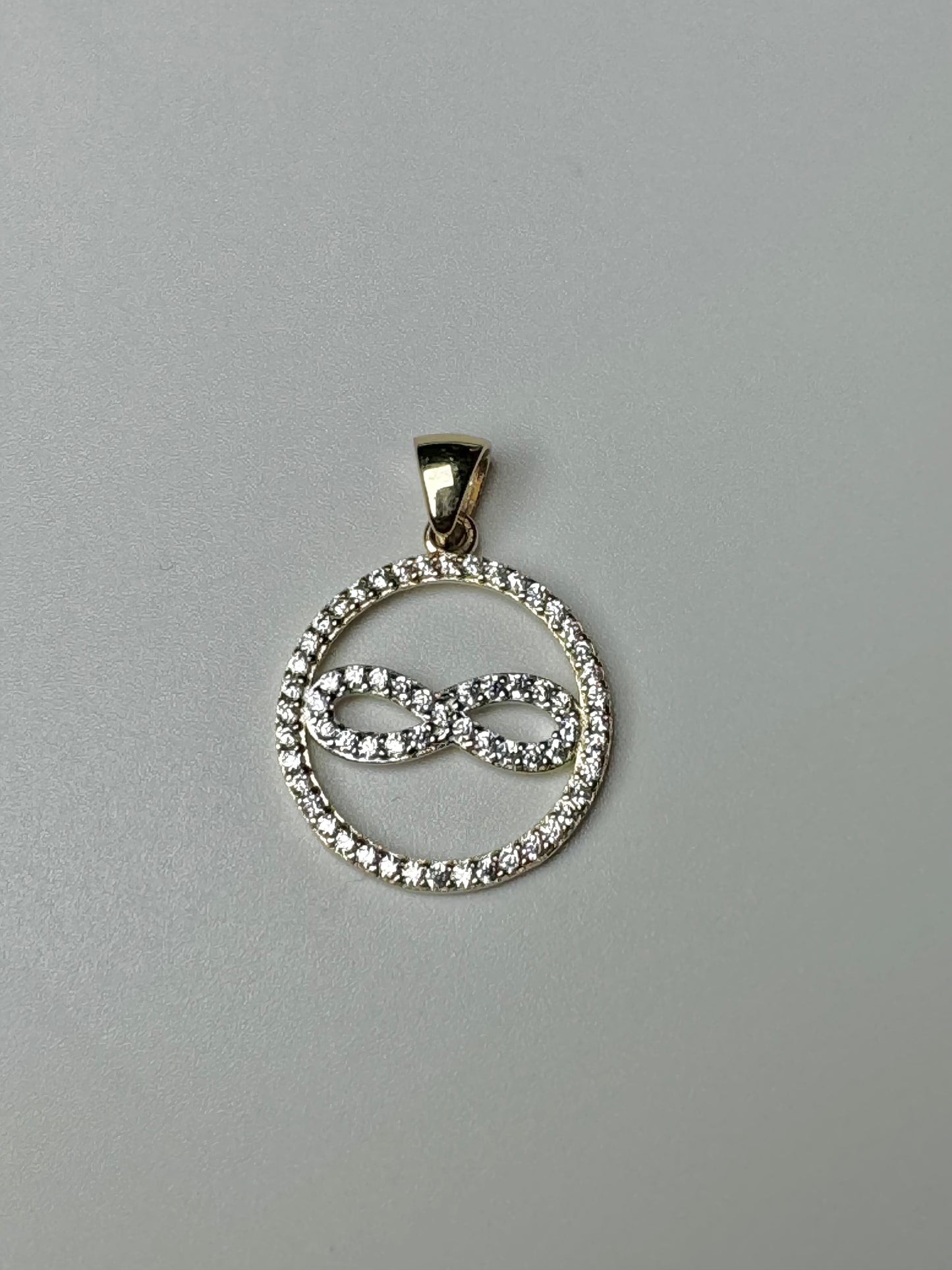 Gold infinity circle pendant with zircon