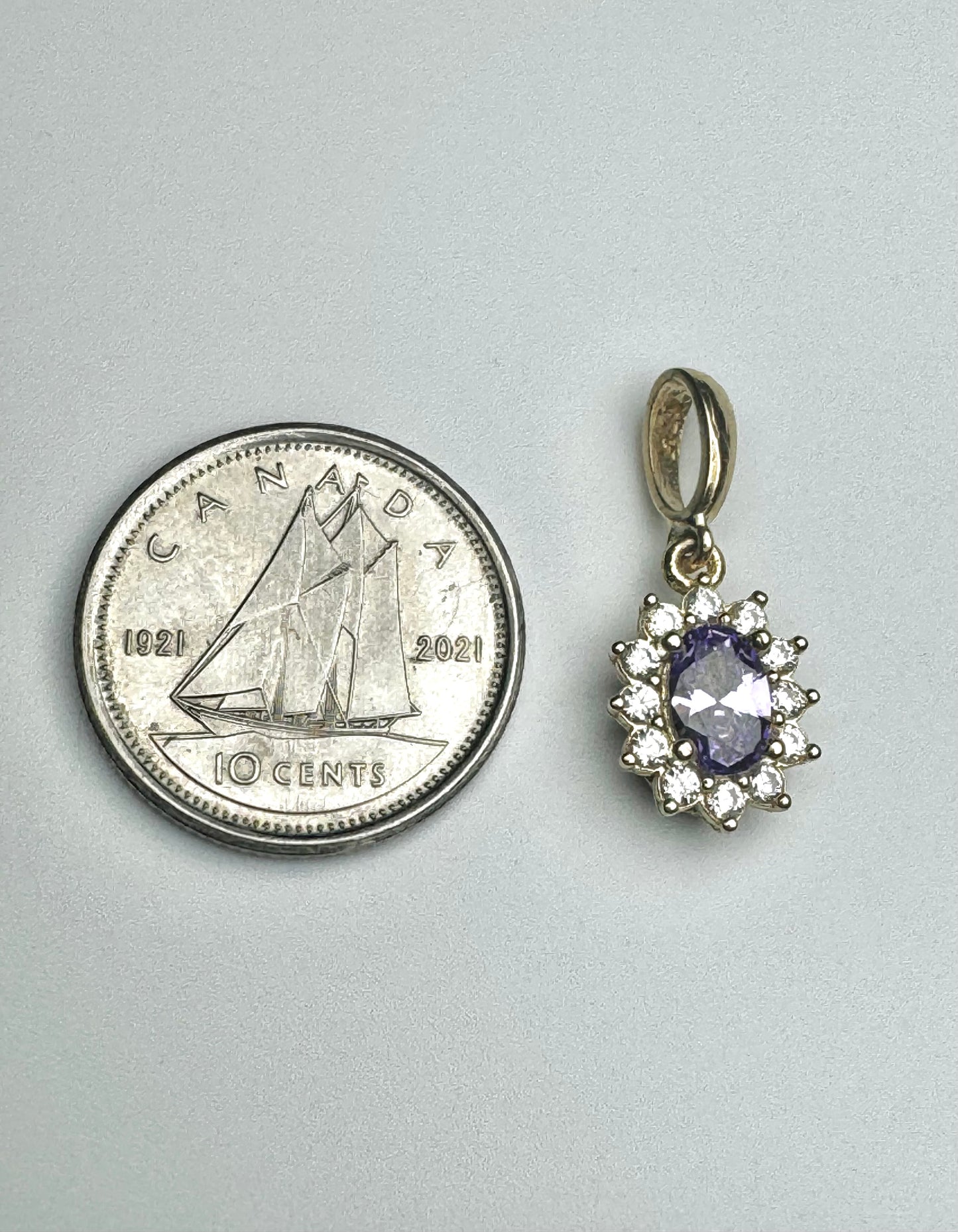 Oval pendant with purple and white zircon