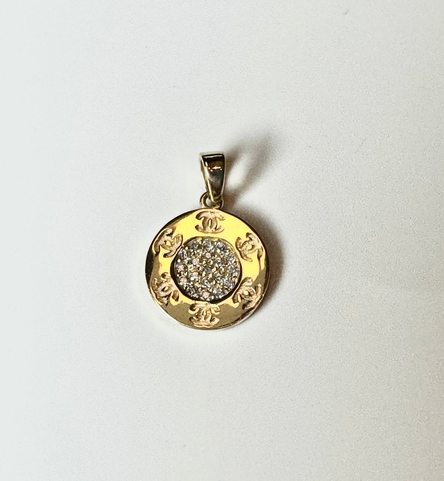 Gold pendant with CC engraving and zircon