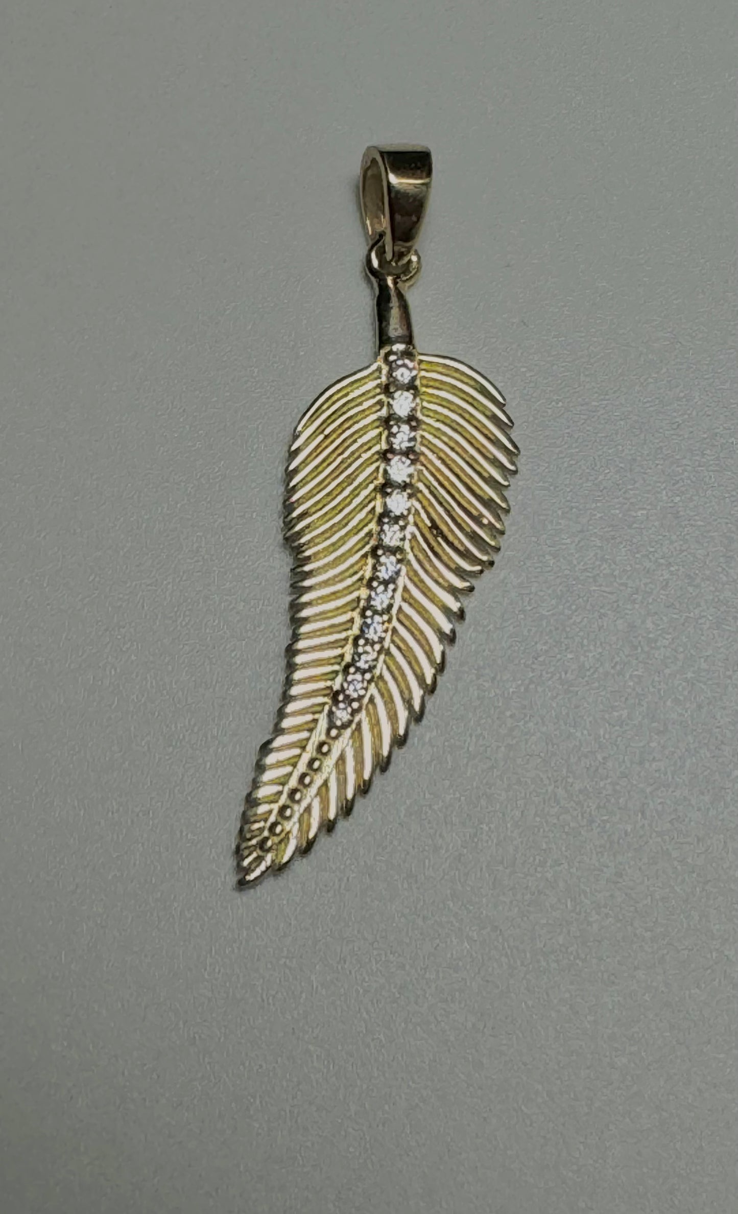 Gold feather pendant with zircon