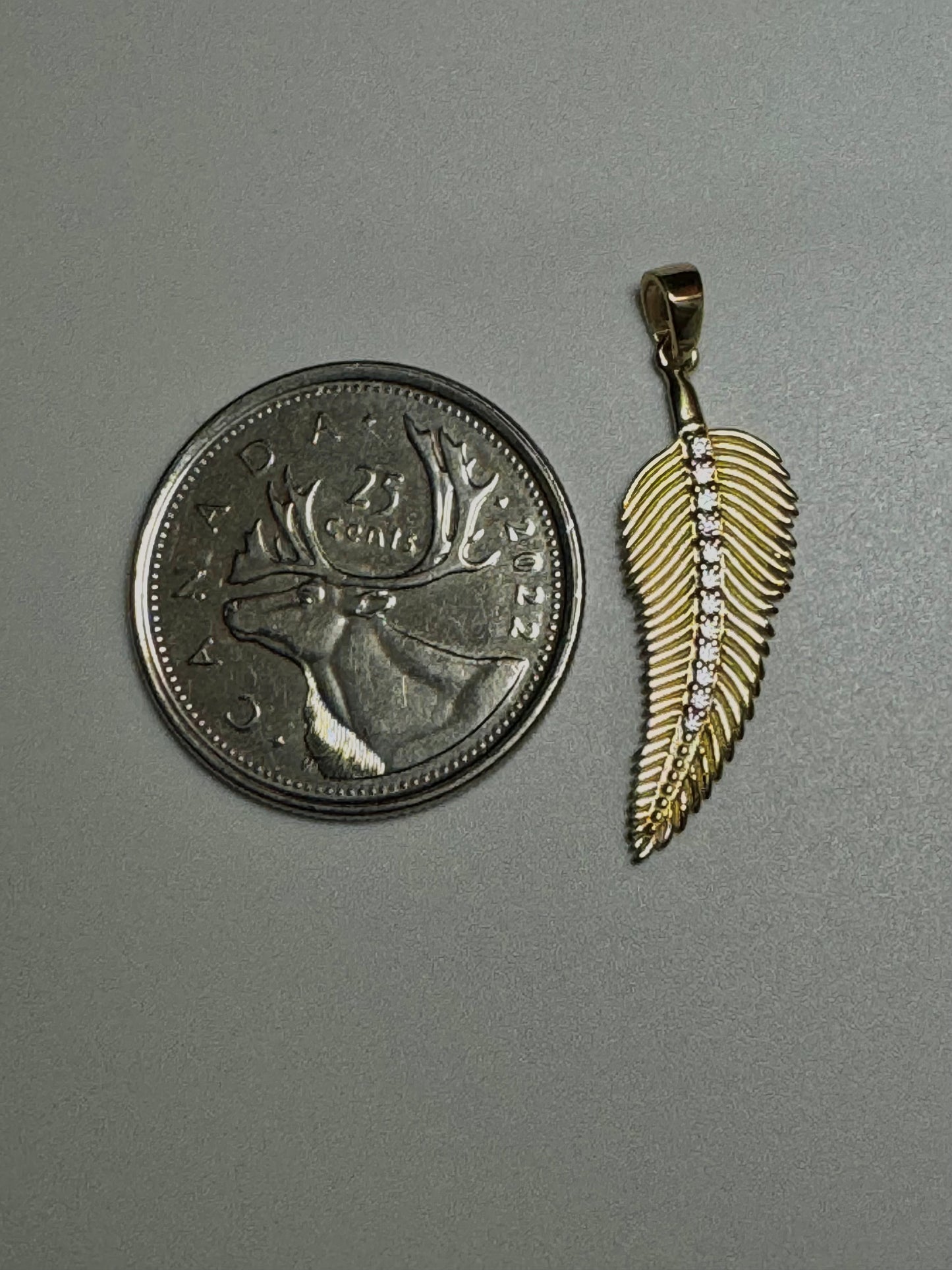 Gold feather pendant with zircon