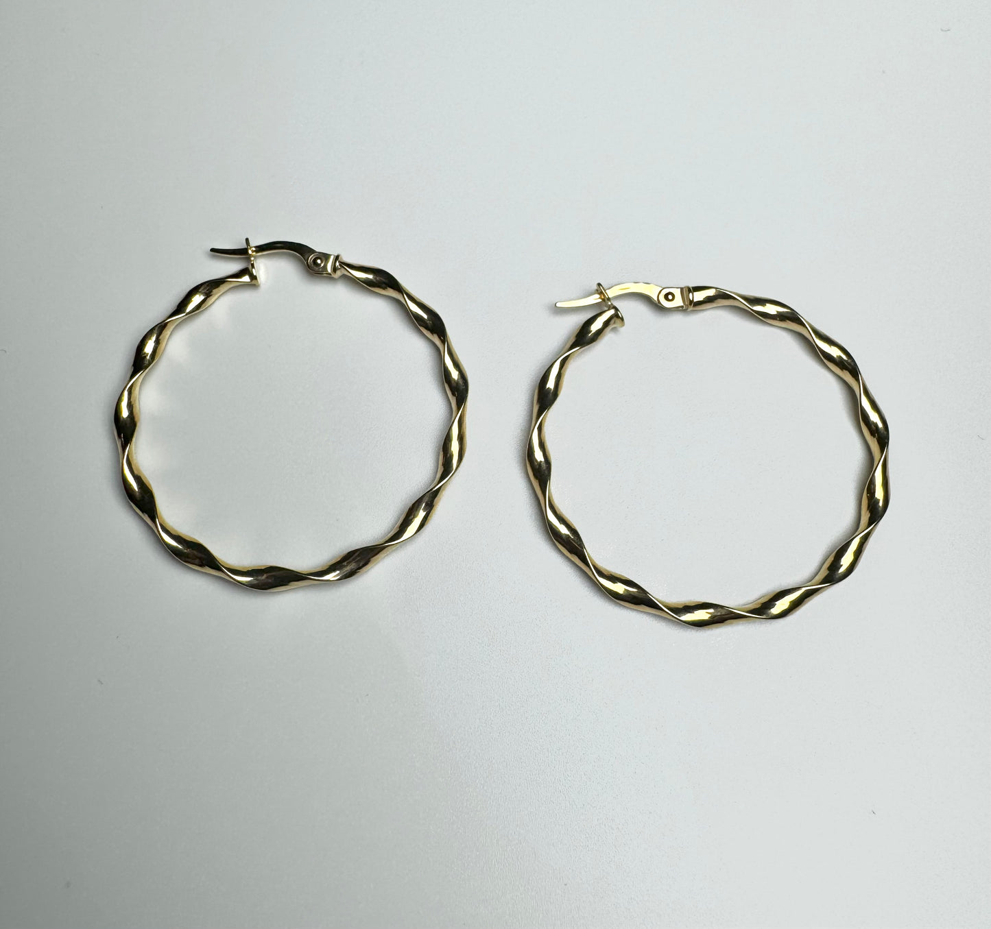 Plain wavy hoop gold earrings