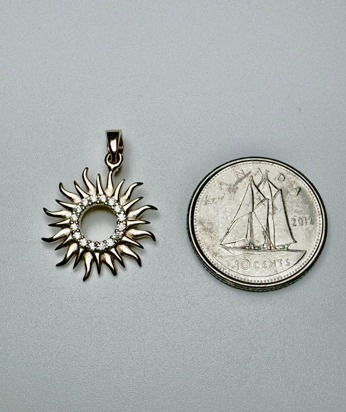 Gold sun pendant with zircon