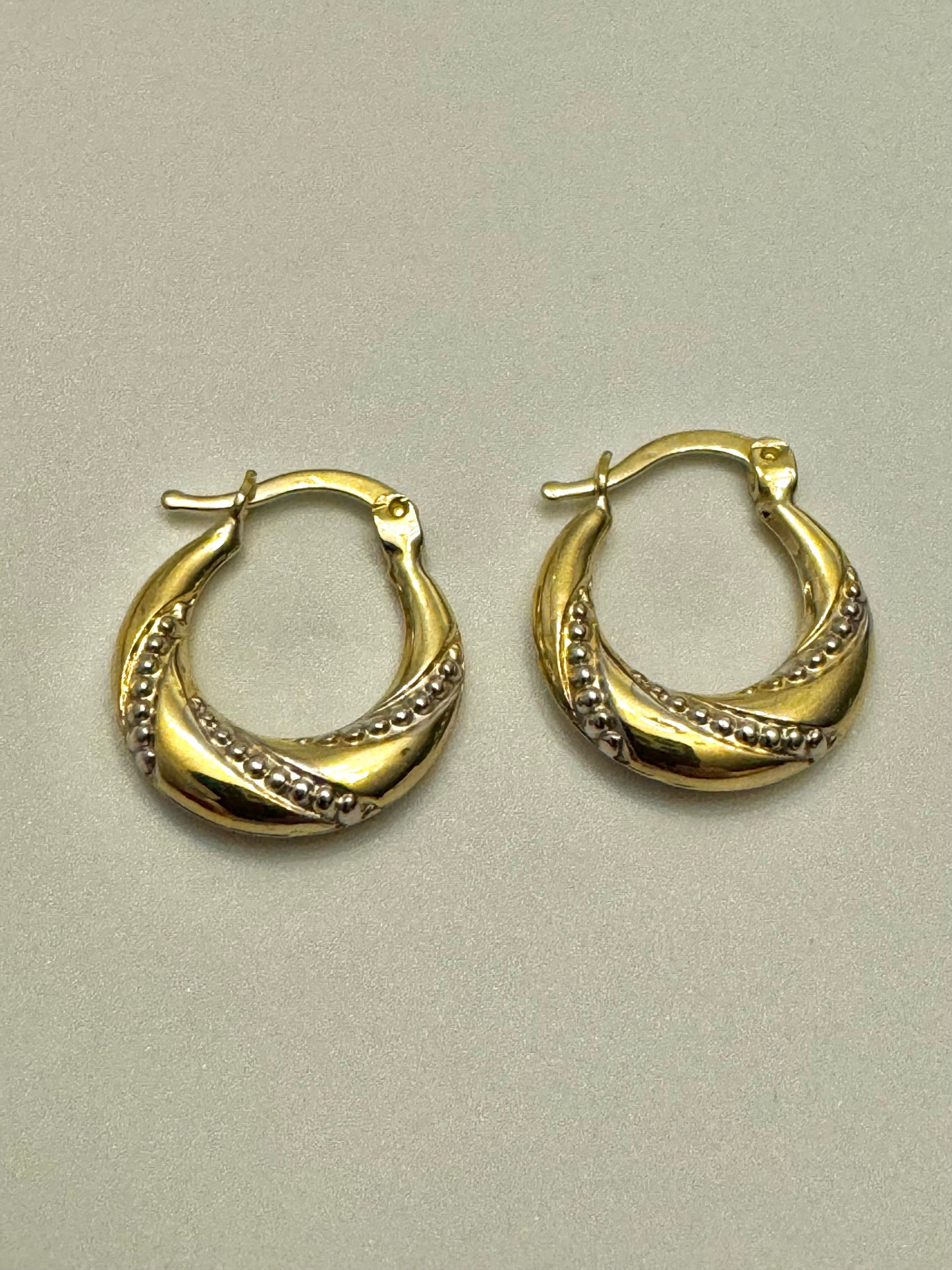 Flat gold earrings with two-tone engraving