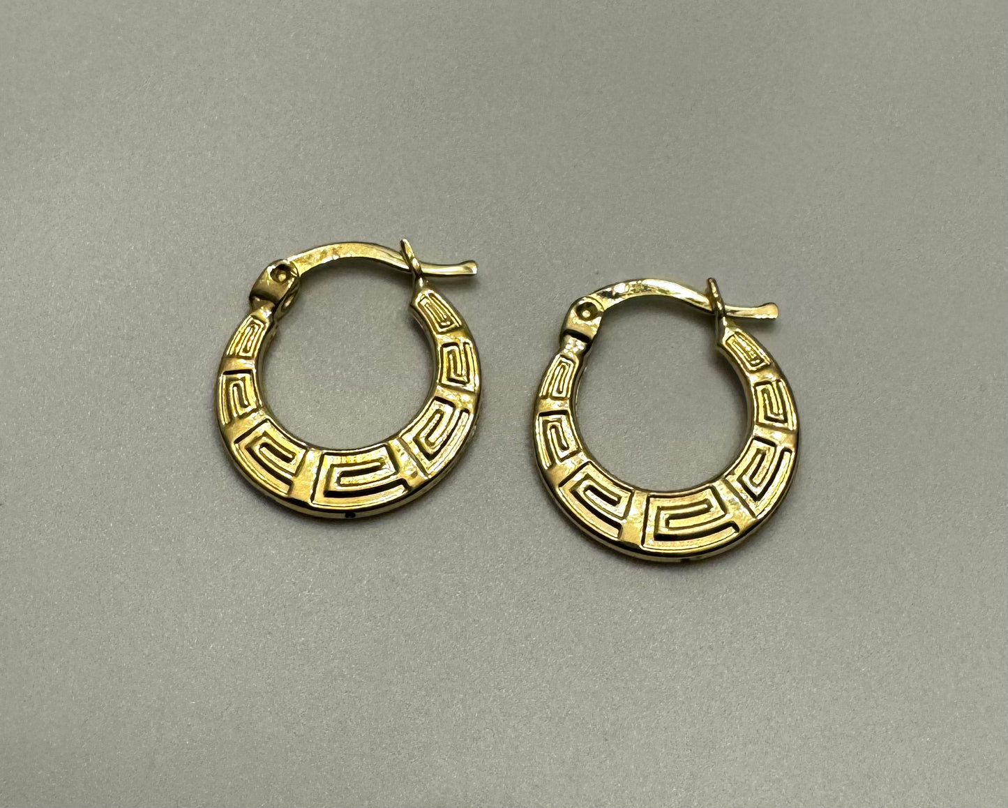 Flat gold medusa earrings