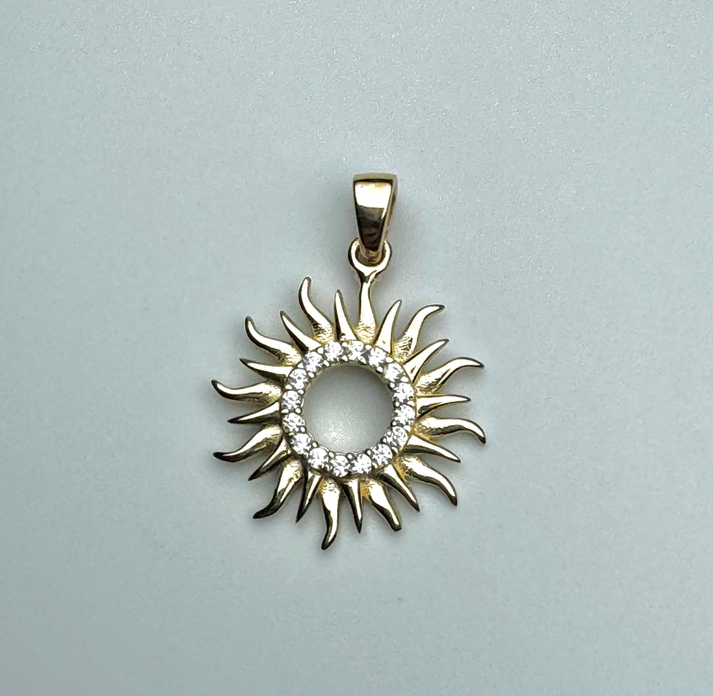 Gold sun pendant with zircon