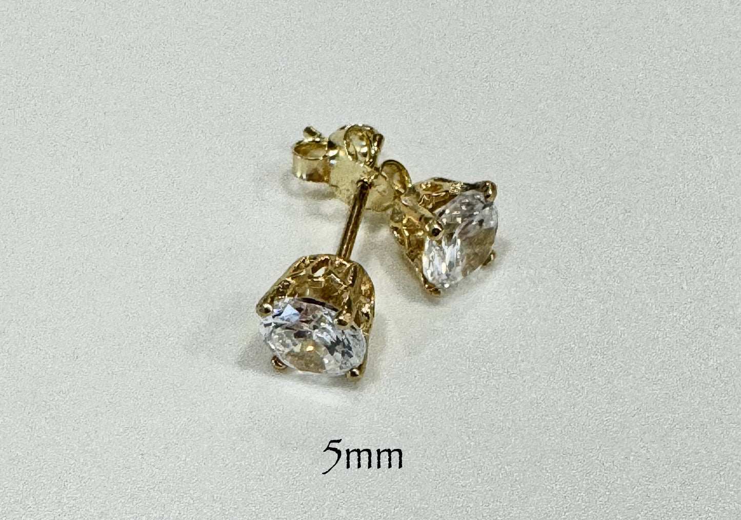 Stud earrings with round white zircon