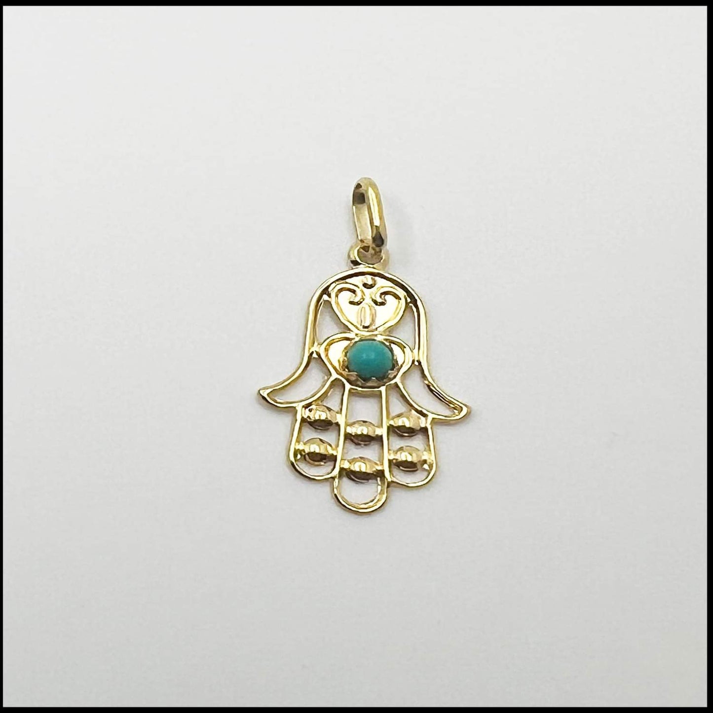 Gold Fatima hand pendant with green zircon