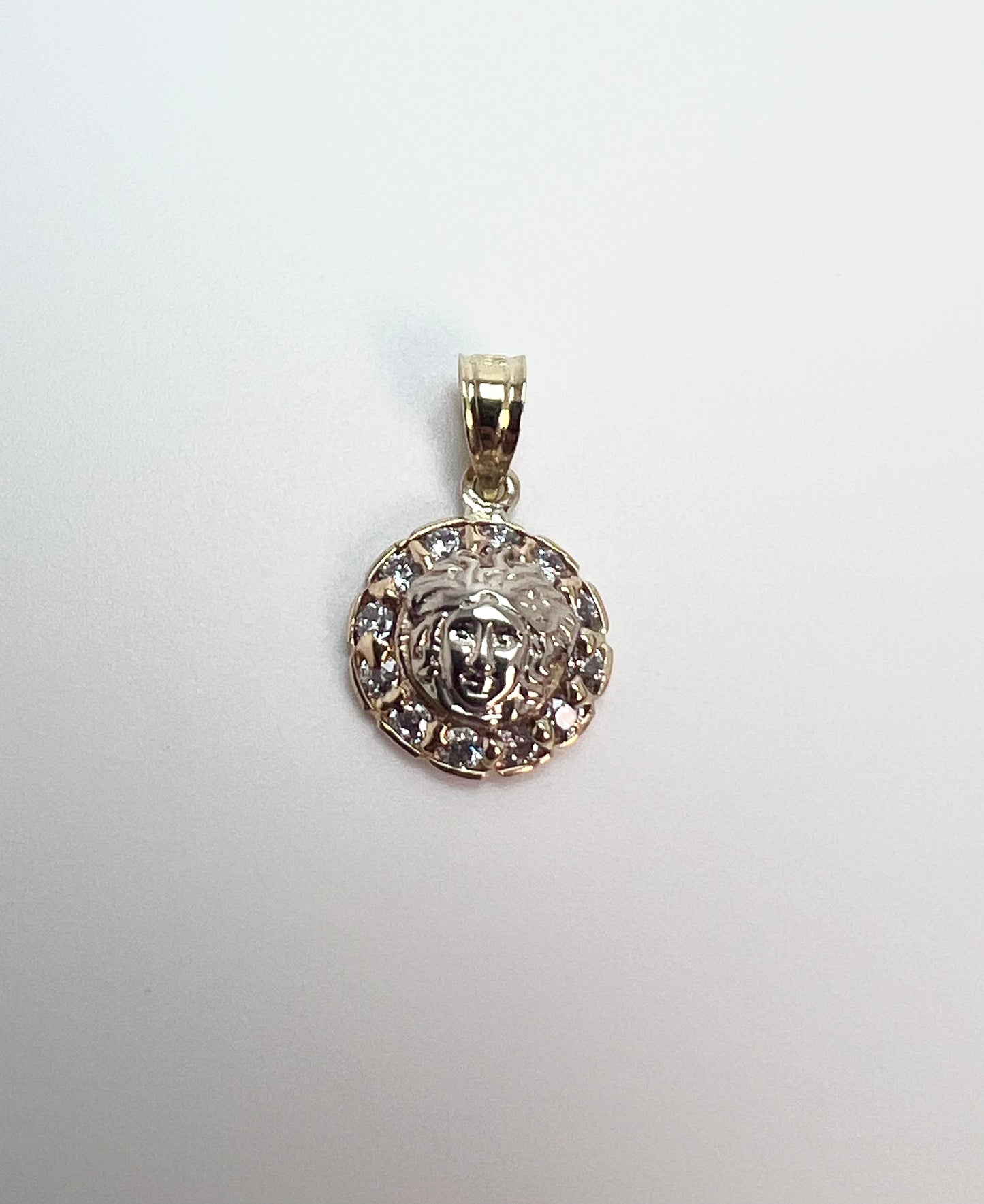 Round gold medusa pendant with zircon