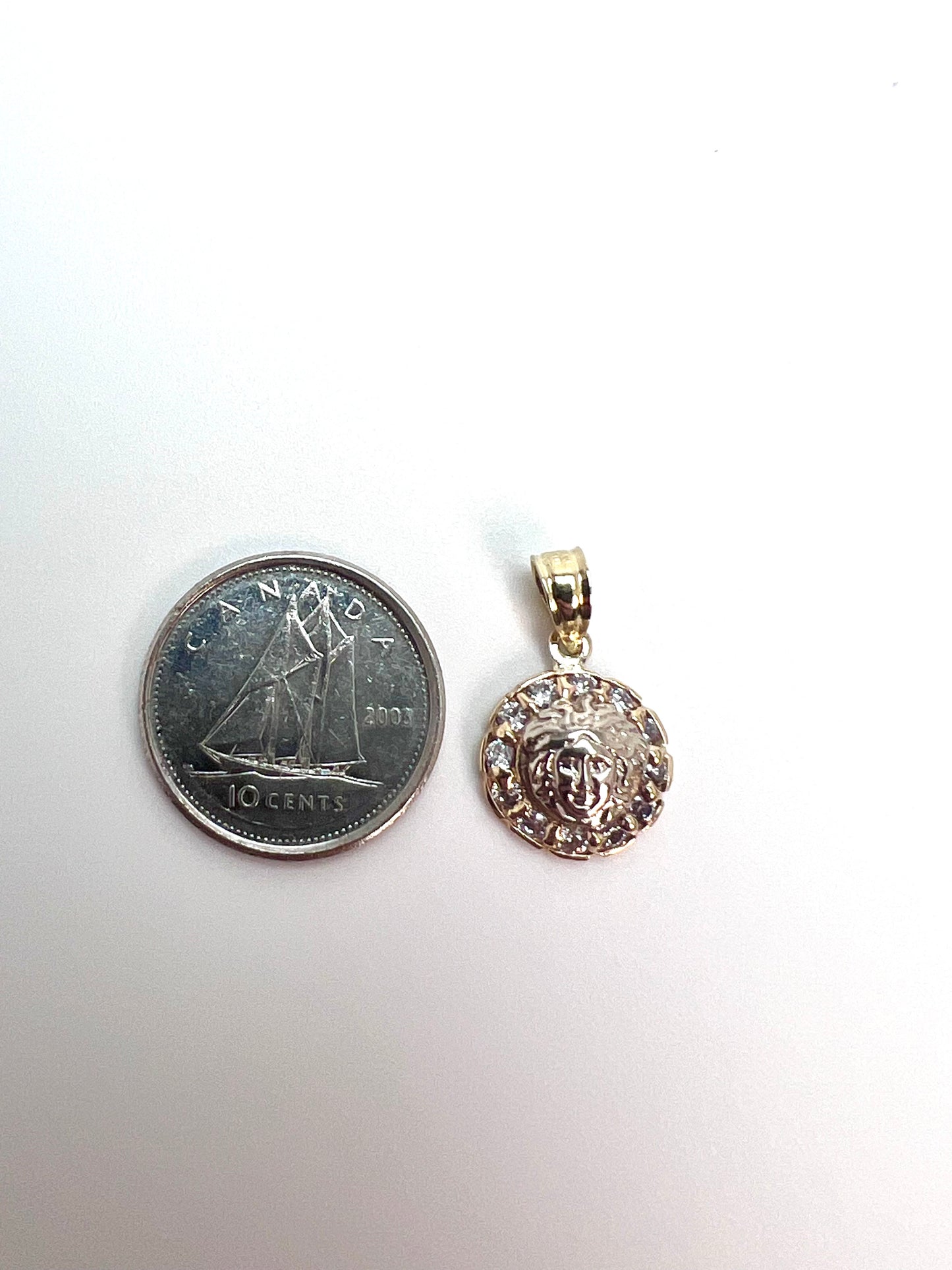 Round gold medusa pendant with zircon